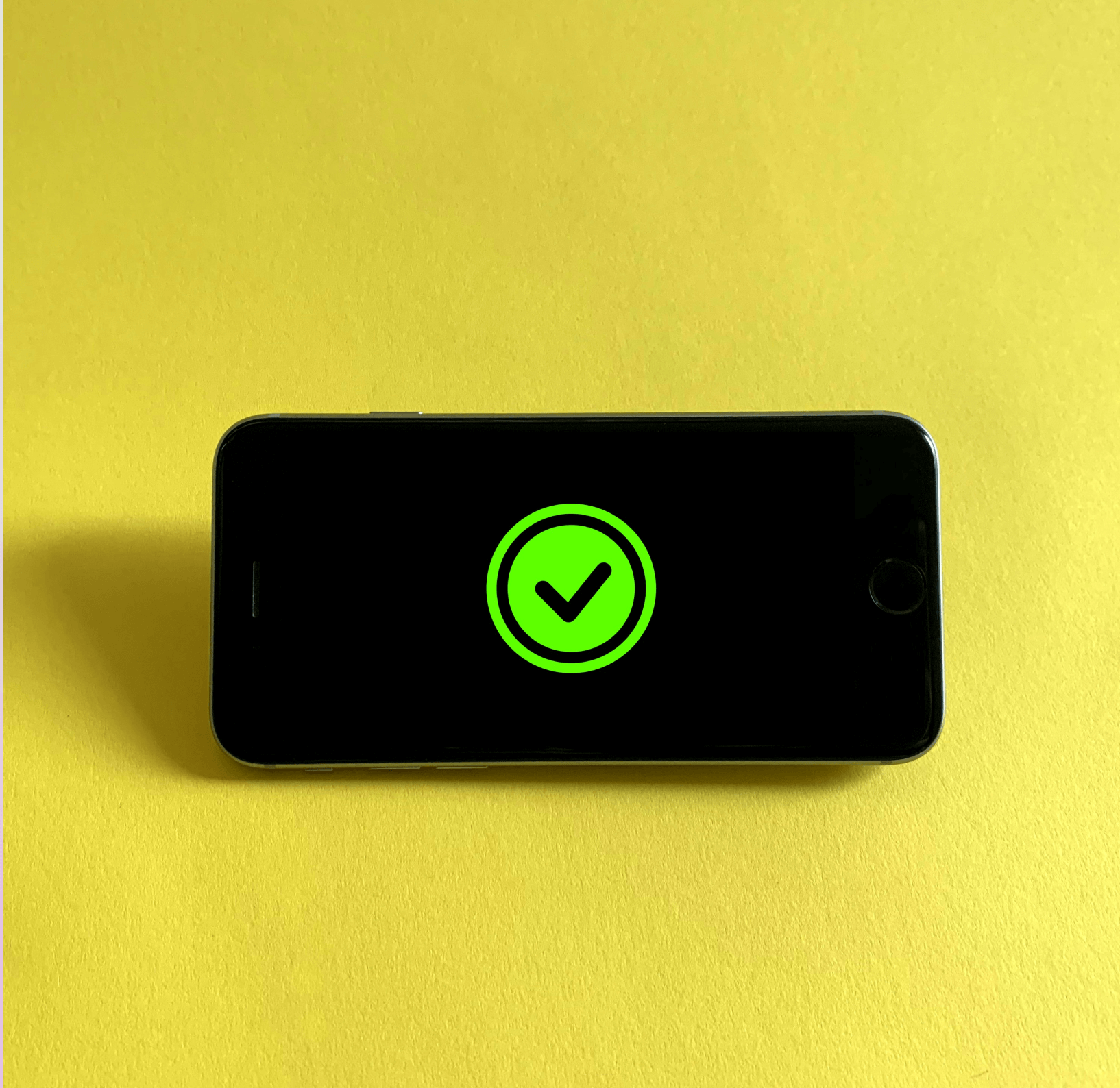 Green checkmark on a black mobile phone screen