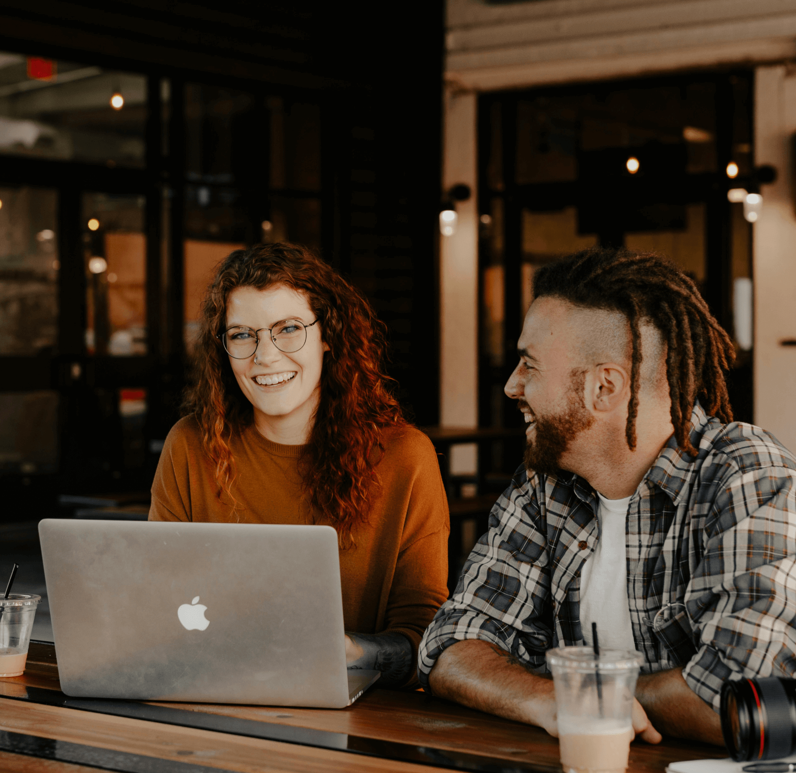 2 happy people at a laptop