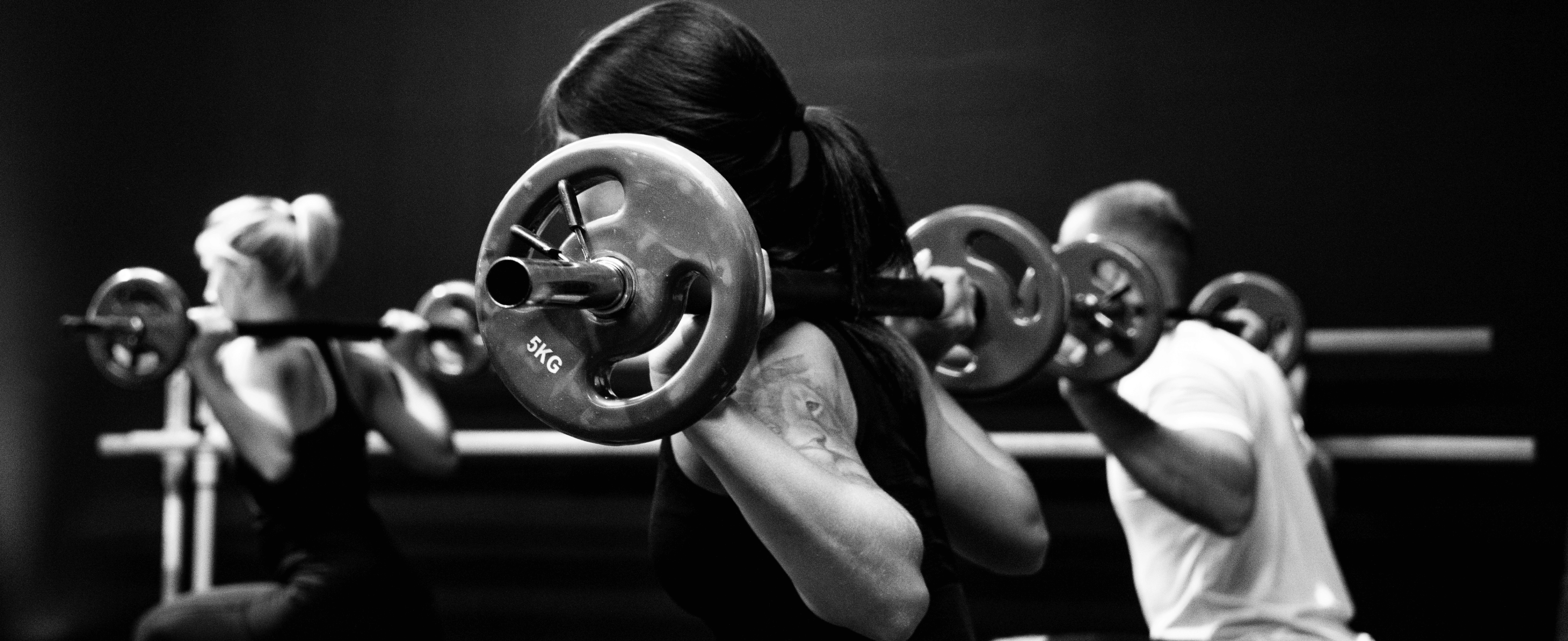 black and white photo of a woman weightlifing