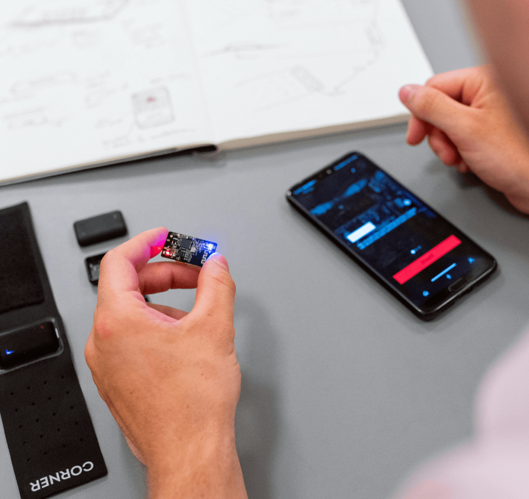 smart phone on a table with a guy holding a memory card